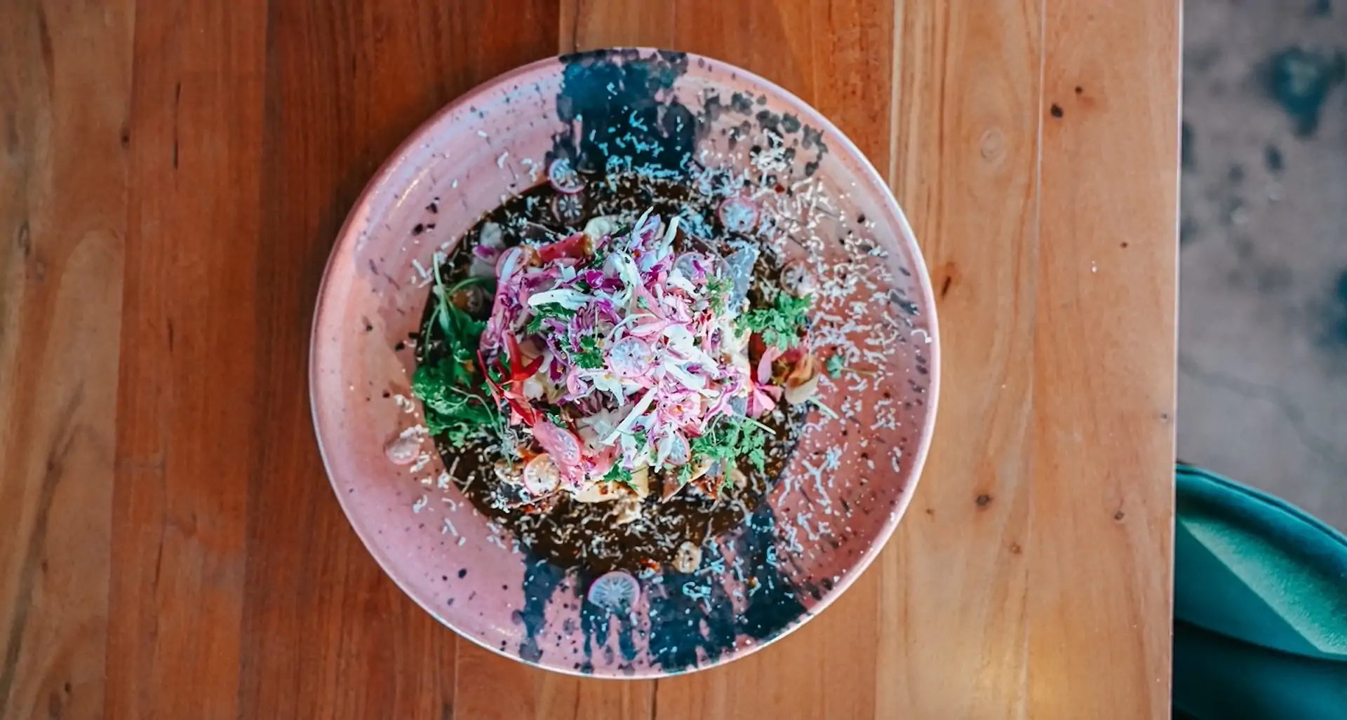 A mole dish on a pink plate at Phoenix restaurant Chilte