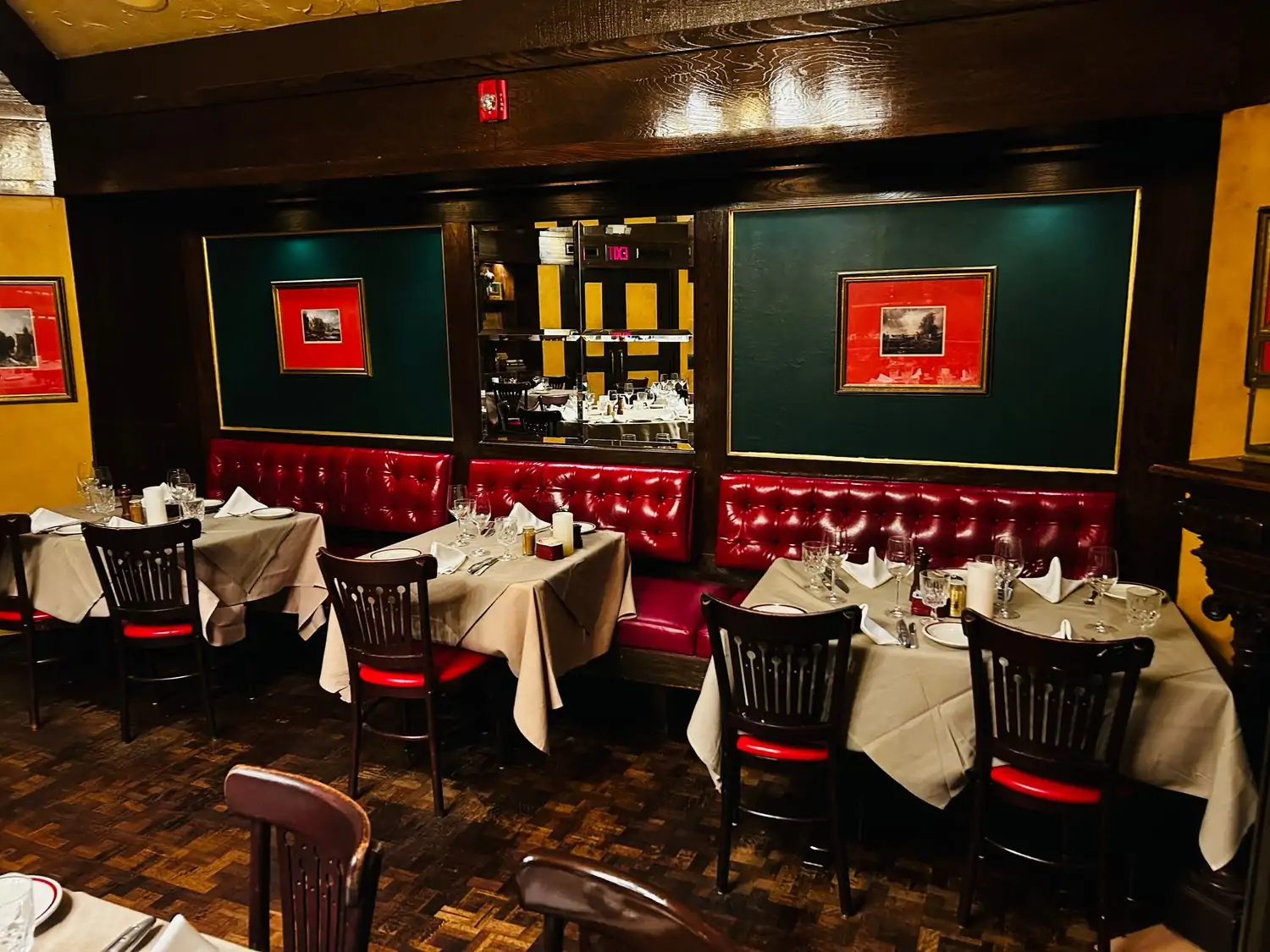 A dining room with vintage furniture, red leather accents, and blonde wood paneling at House of Prime Rib, one of the best steak restaurants in San Francisco, on OpenTable.