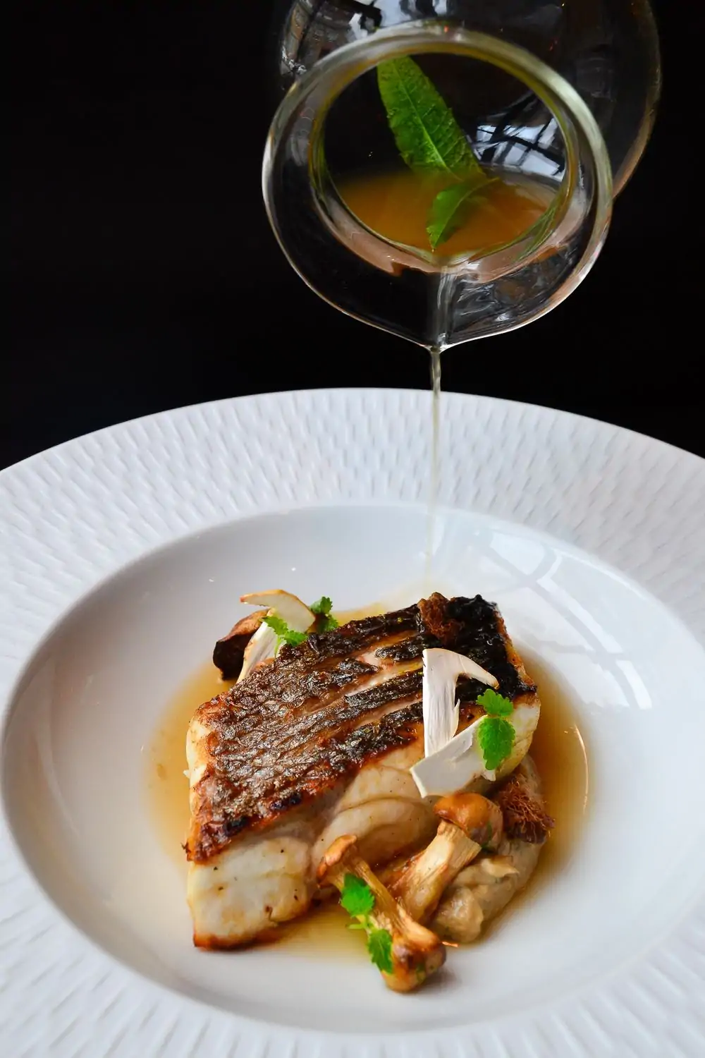 A rich, brown gravy poured over a flame-grilled cut of premium pork at Alexander’s Steakhouse, one of the best steak restaurants in San Francisco, on OpenTable.