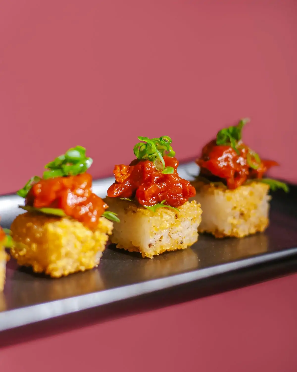Golden crispy rice squares served at PLANTA, one of the best vegetarian restaurants in DC available on OpenTable.