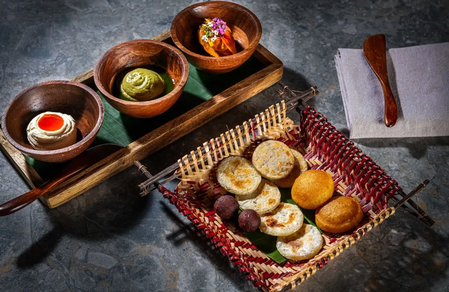 This is an overhead view of the first course at Mita in Washington, DC, one of the best vegetarian restaurants on OpenTable. It shows a selection of arepas on a tray with three bowls of various dips.