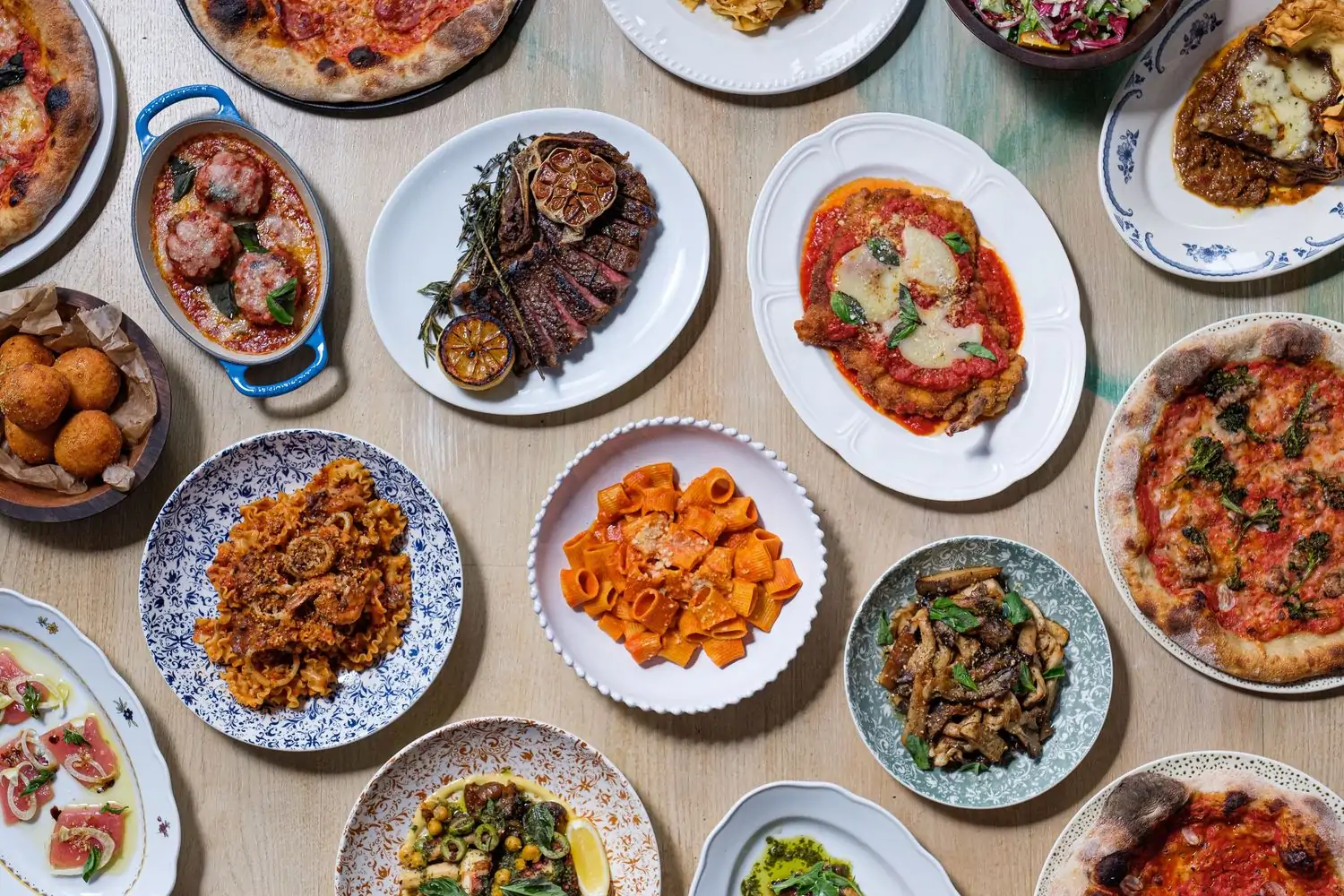 Plates of pasta, steak, arancini, and more Italian dishes at Alla Vita, an OpenTable restaurant in Chicago.