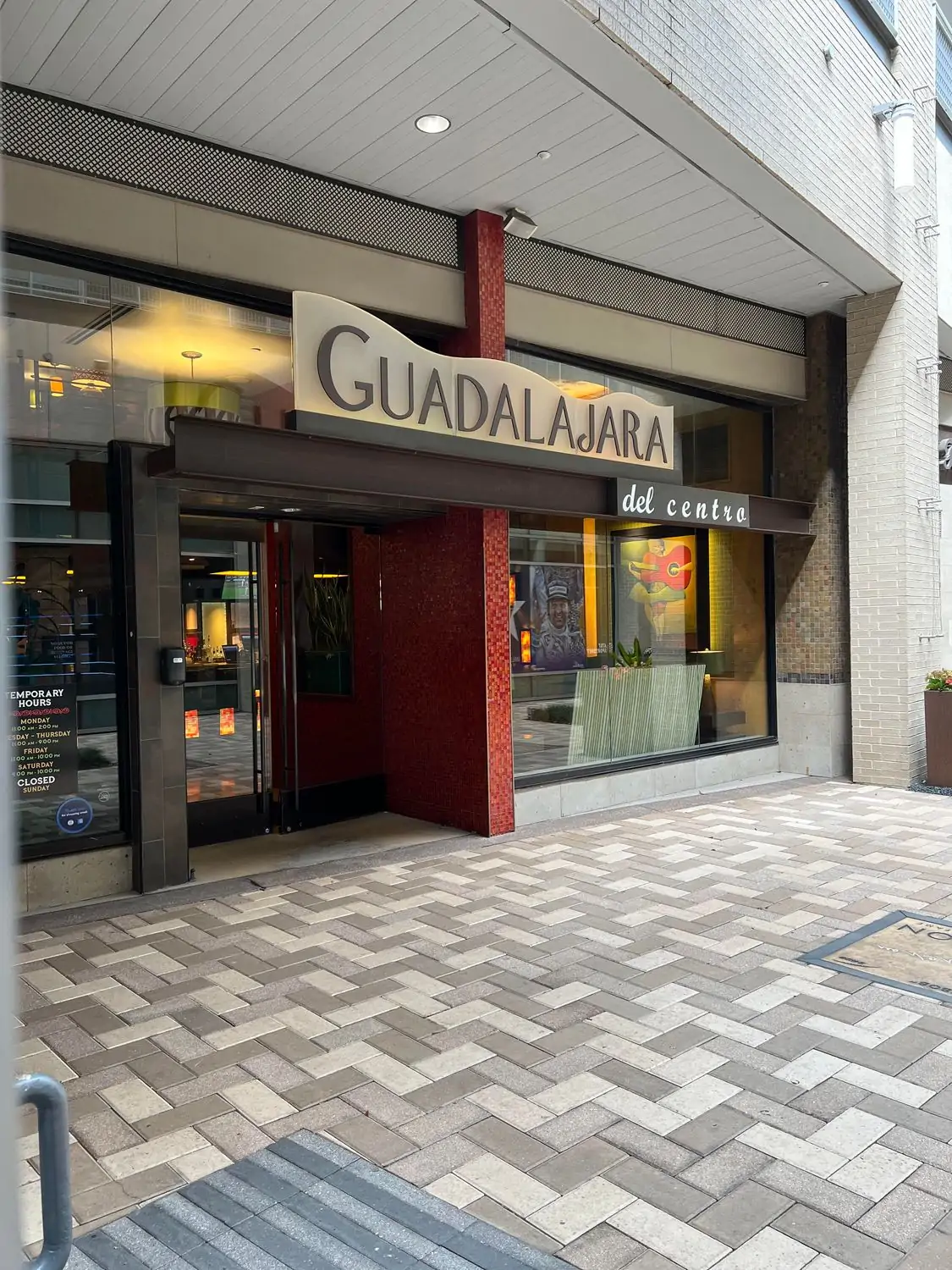 The exterior of Guadalajara Del Centro, one of the best Mexican restaurants in Houston on OpenTable, with a brick entryway and expansive glass windows that show the booths inside with musical artwork on the walls.