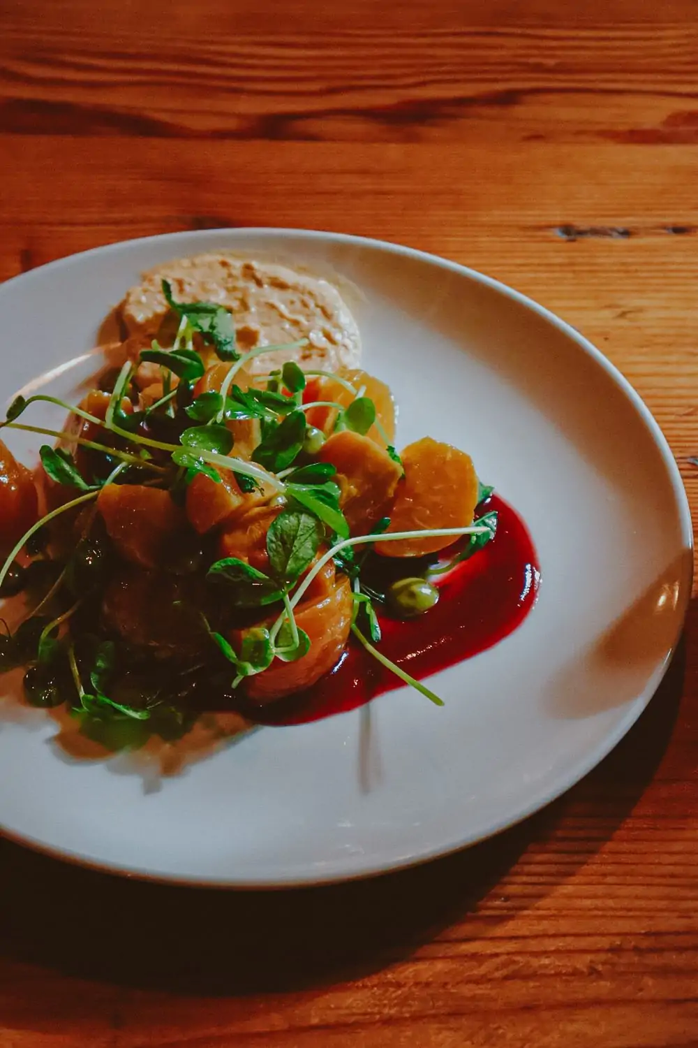 This artfully plated dish from Forage in Cambridge, one of the best Boston vegan restaurants at OpenTable, presents golden beets, fresh greens, and a rich beet purée.