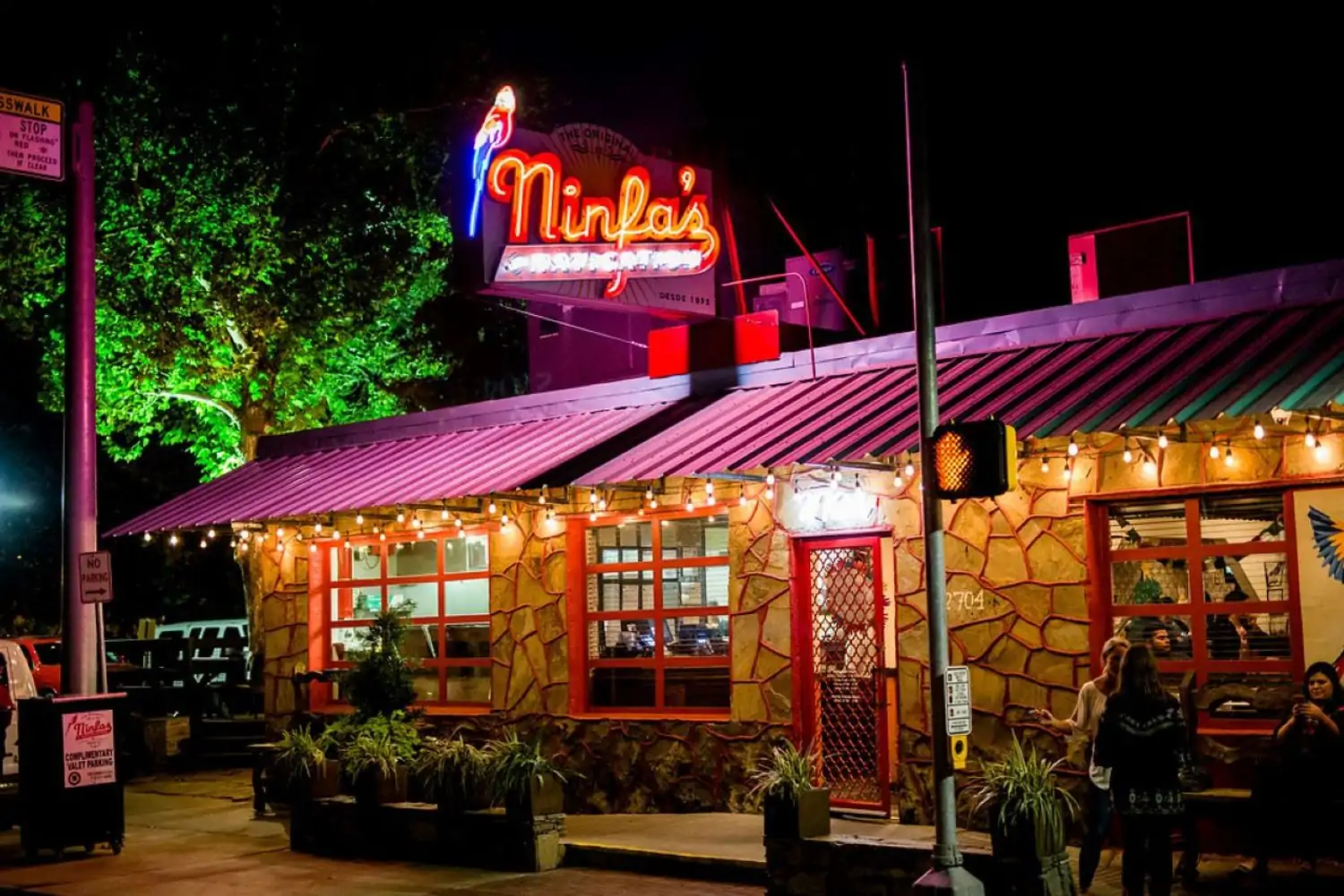The exterior of The Original Ninfa's, one of the best Mexican food restaurants in Houston available at OpenTable, with neon lights and cursive writing to spell out the restaurant name.