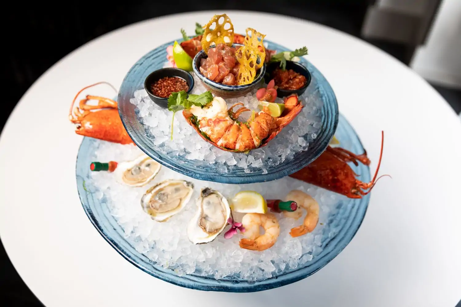 A two-level tower of seafood on ice that includes raw oysters, shrimp, mignonette sauce, and cocktail sauce at Gerrard Street Kitchen in Dupont Circle, DC. Reserve a table on OpenTable.