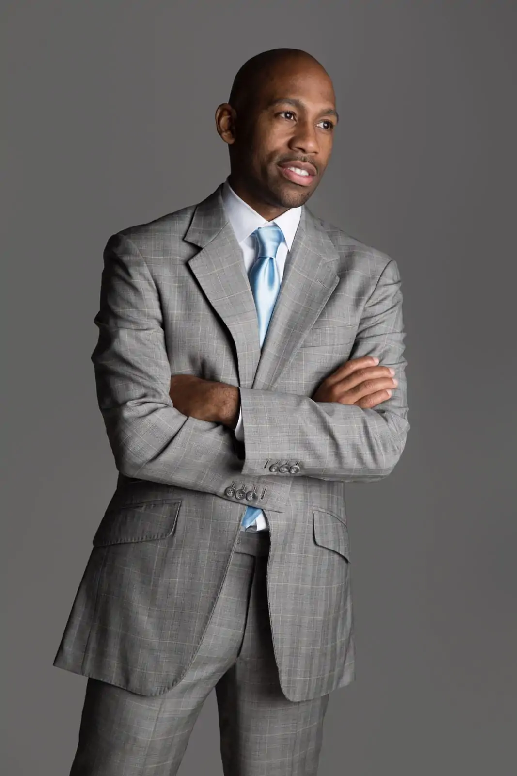Kevin Kelley, owner of Kitchen + Kocktails in Dallas and featured on OpenTable, wearing a grey plaid suit and light blue tie.