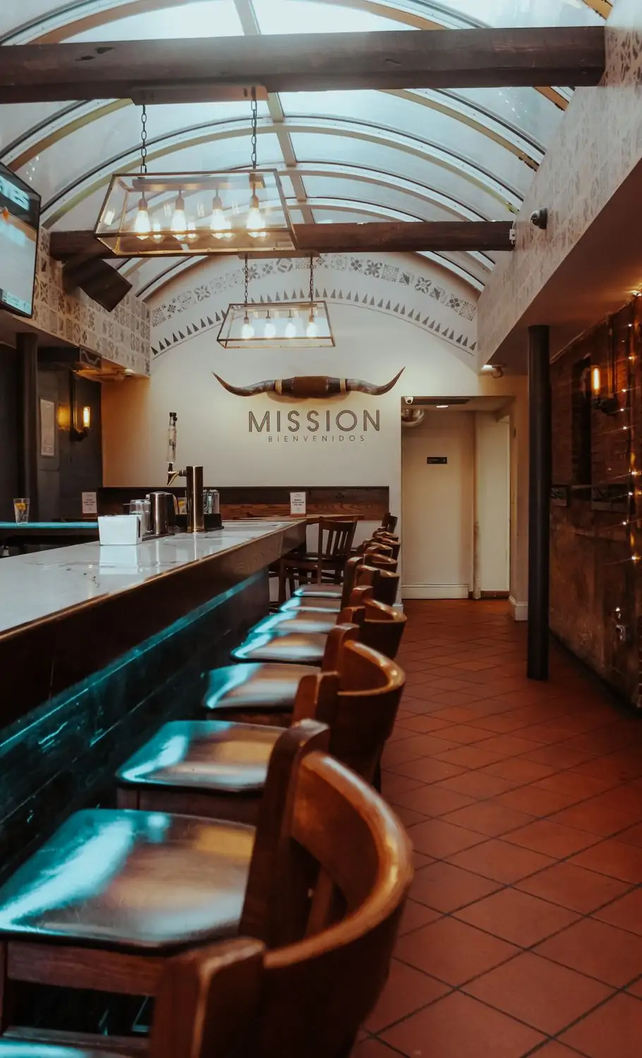 At one of the best restaurants Dupont Circle, DC, Mission Dupont, there is a large main marble under a glass atrium ceiling with wooden beams and a set of cattle horns on the wall. Reserve on OpenTable.