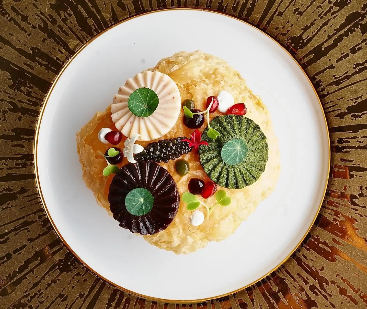 An intricately plated dish featuring colorful garnishes and delicate textures highlights the artistic culinary style of Musaafer, one of Houston’s best Indian restaurants, available on OpenTable.