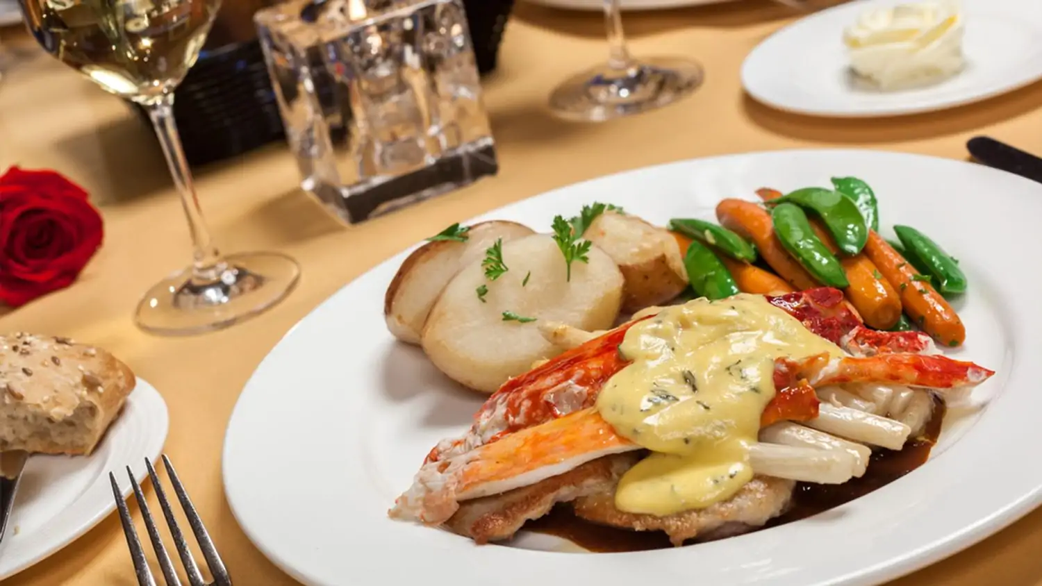 A lobster with a side of potatoes and vegetables at Hugo’s Cellar, one of the best restaurants on Fremont Street, Las Vegas, available on OpenTable.
