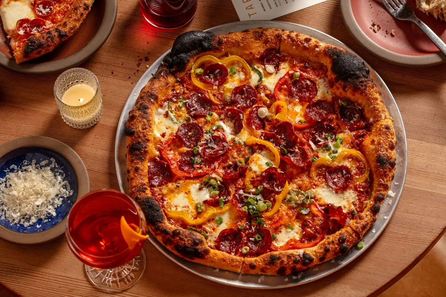 An oven-charred pizza topped with pepperoni, bell peppers, tomato sauce, and mozzarella at Tartine Manufactory - San Francisco, a restaurant in San Francisco on OpenTable.
