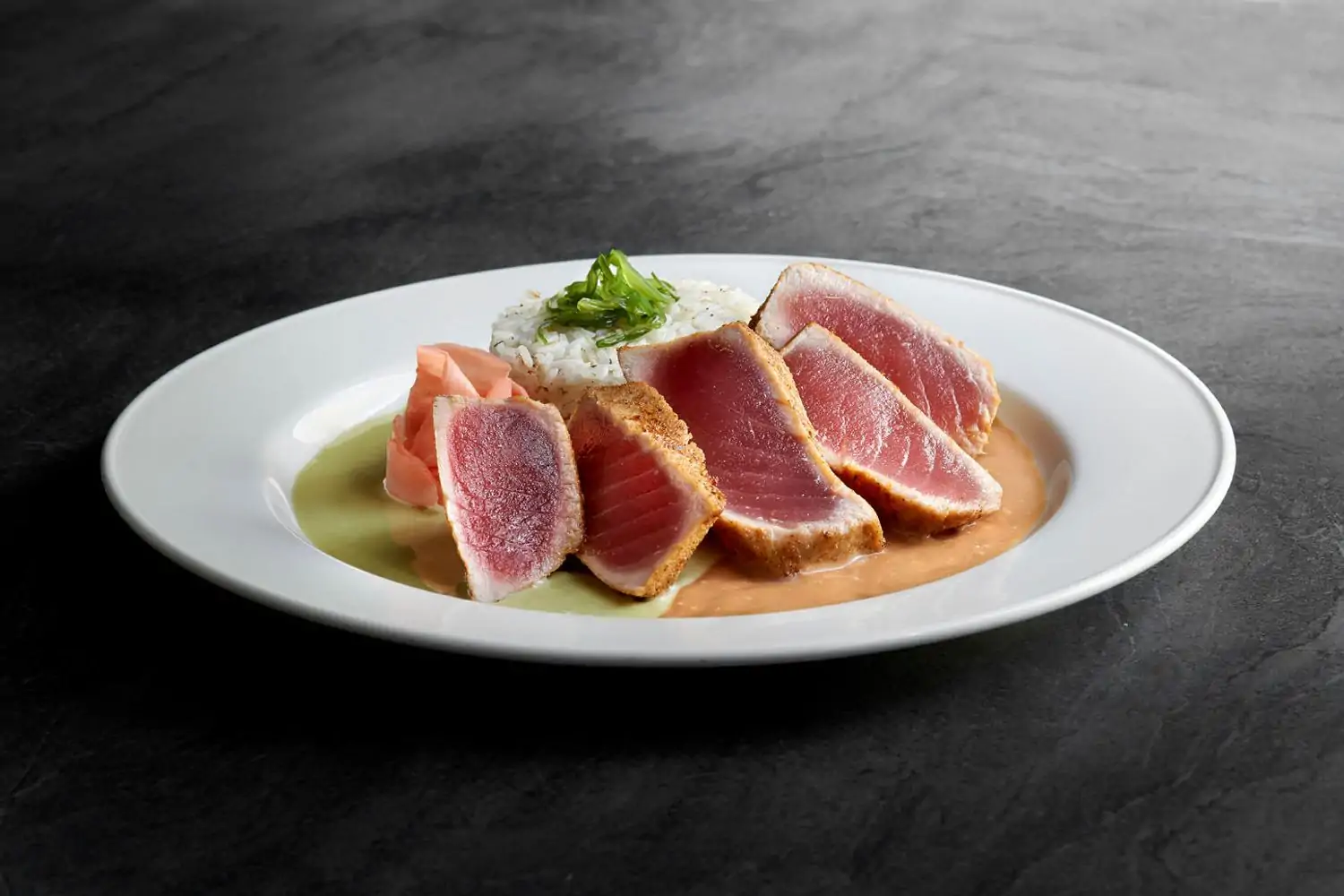 A plate containing fresh fish beside a pile of rice with garnish at Chart House Restaurant - Golden Nugget - Las Vegas, available on OpenTable.