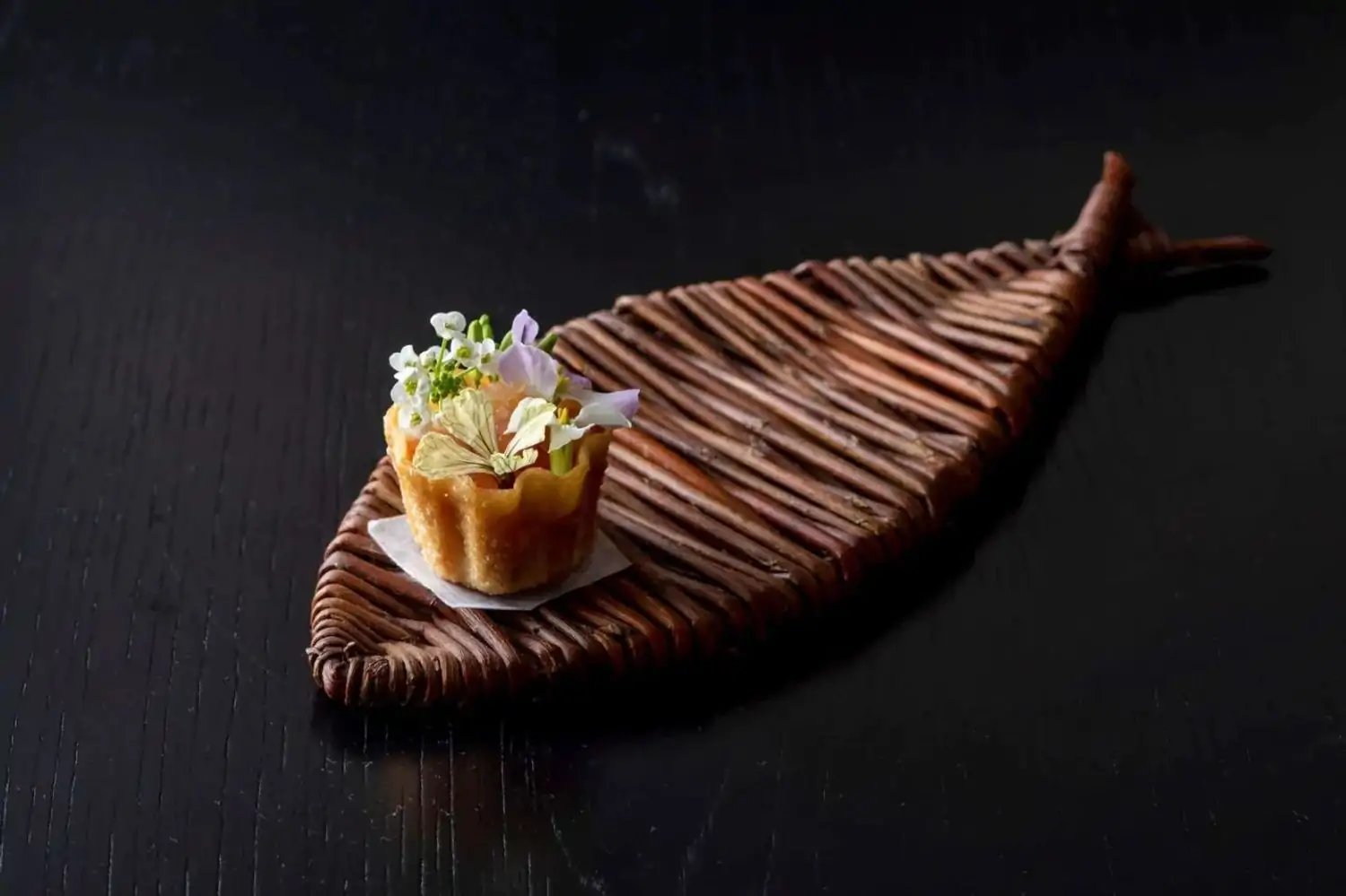 A fish-shaped plate with an amuse-bouche at Reverie, one of the best MICHELIN-star restaurants in Washington DC on OpenTable.