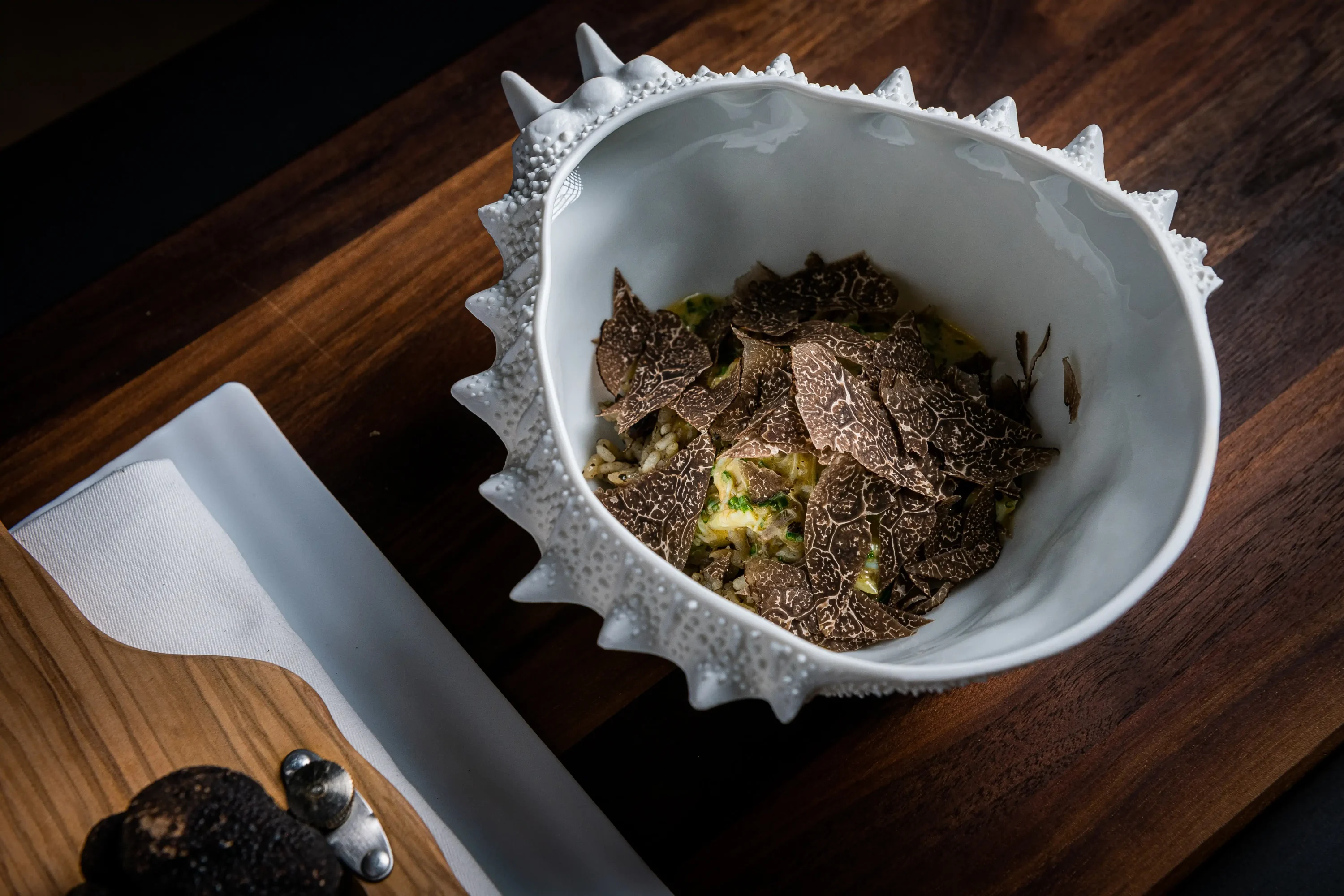 A bowl shaped like a crab shell filled with crab rice topped with truffles at Jônt, one of the best MICHELIN-Starred restaurants in Washington DC, on OpenTable.