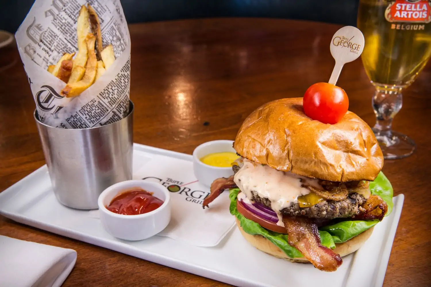 A big, juicy burger with melted cheese at Triple George Grill, one of the best restaurants in downtown Las Vegas, found on OpenTable.