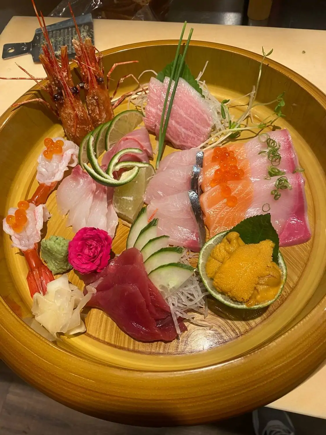 Large platter with various types of sashimi, including shrimp, tuna, and whitefish, garnished with roe, wasabi, and vegetables at Umami Steak & Sushi Bar, the best Japanese restaurant in Philadelphia you can book on OpenTable.