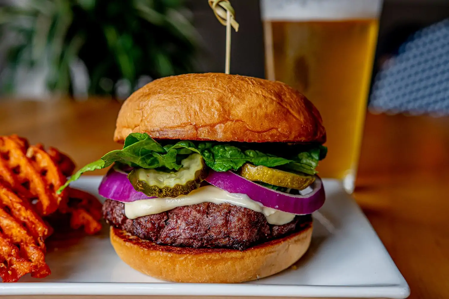 A hearty burger with golden sweet potato waffle fries. Jasper's, one of the best family friendly restaurants in Nashville. Reserve on OpenTable.