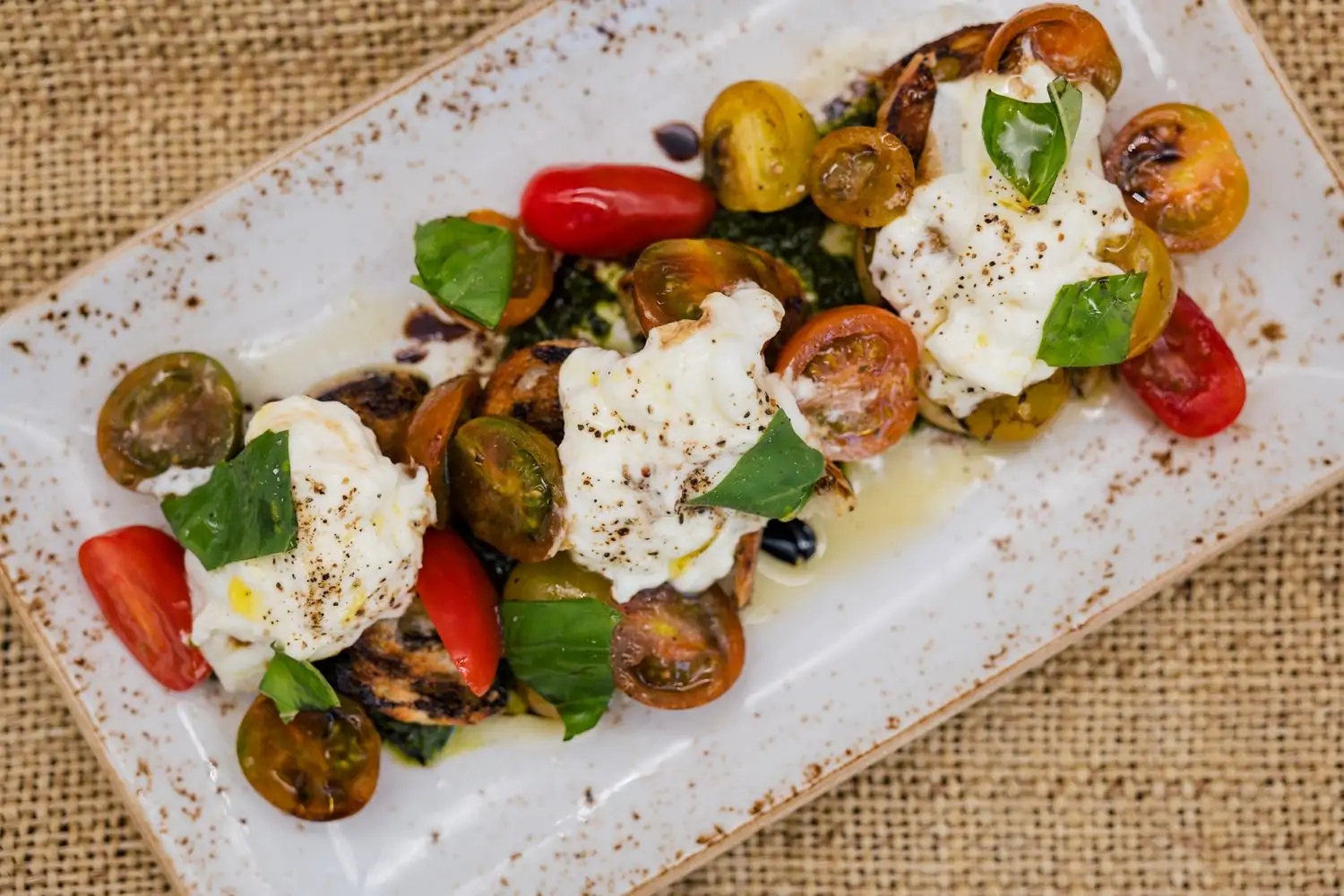 A plate of caprese salad with tomatoes, mozzarella, and basil leaves at Bar Verde, one of the best restaurants in Century City on OpenTable.