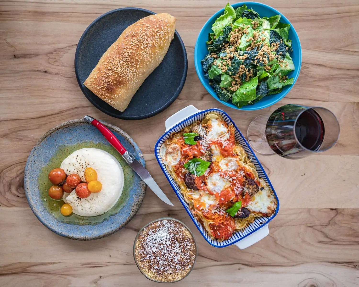 At L’Oca d’Oro in Austin, family-sized portions of Italian-inspired dishes alongside a glass of red wine. Book on OpenTable.