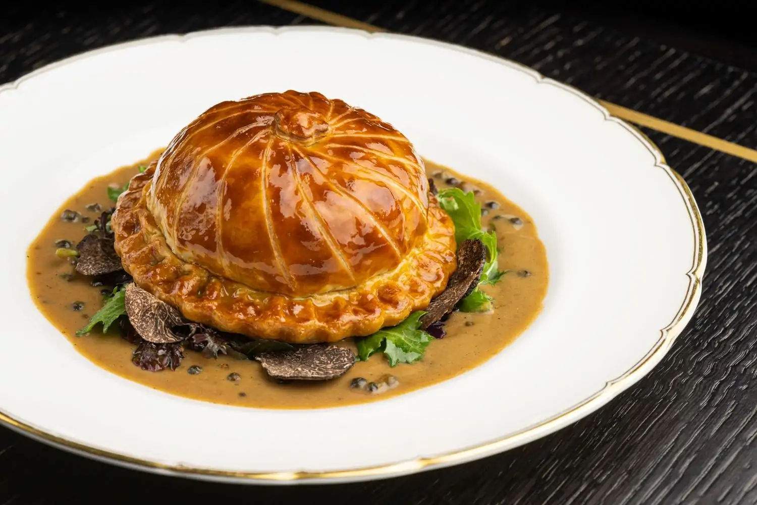 A close-up of a dish en croute in sauce at pasjoli, one of the best restaurants in Santa Monica, CA. Book on OpenTable.