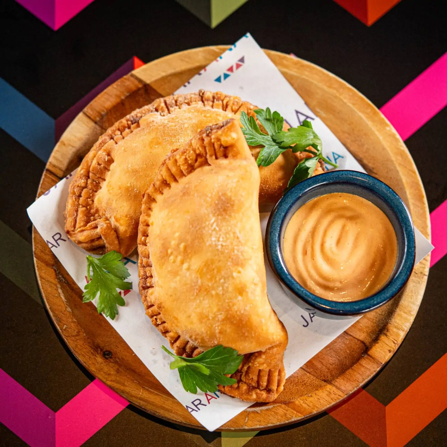 An overhead view of empanadas and sauce at Jarana Aventura - Peruvian Cuisine & Pisco Bar, one of the best family friendly restaurants in Miami. Book on OpenTable.