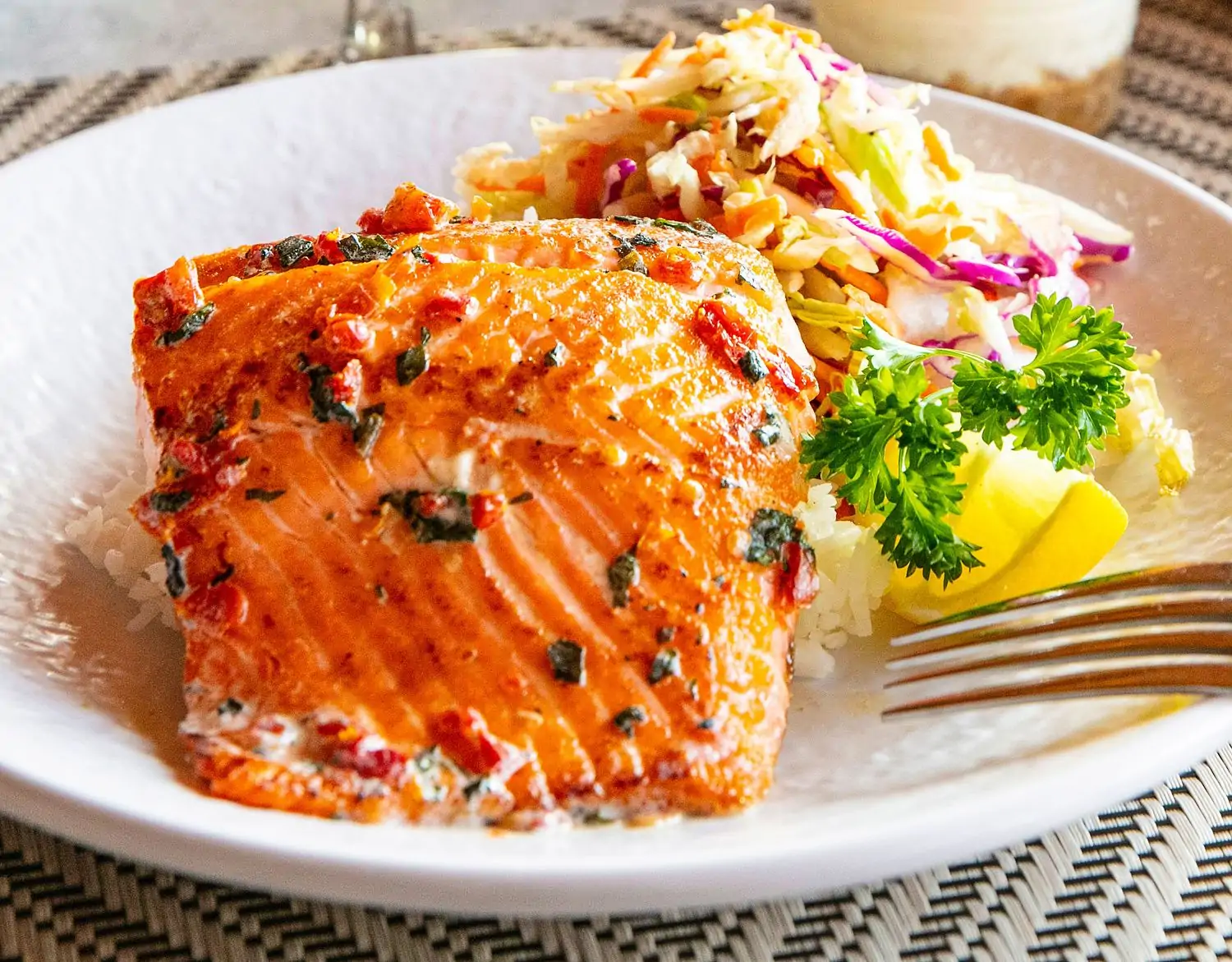 A plate with grilled and seasoned salmon, rice, and colorful coleslaw at Anthony's HomePort in Seattle, available on OpenTable.