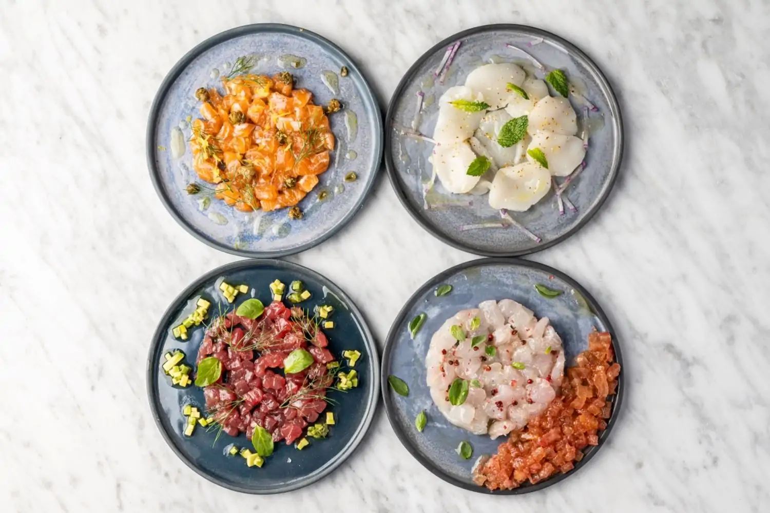 A table setting containing plates of raw fish at Capri at Eataly Los Angeles, one of the best Century City restaurants on OpenTable.