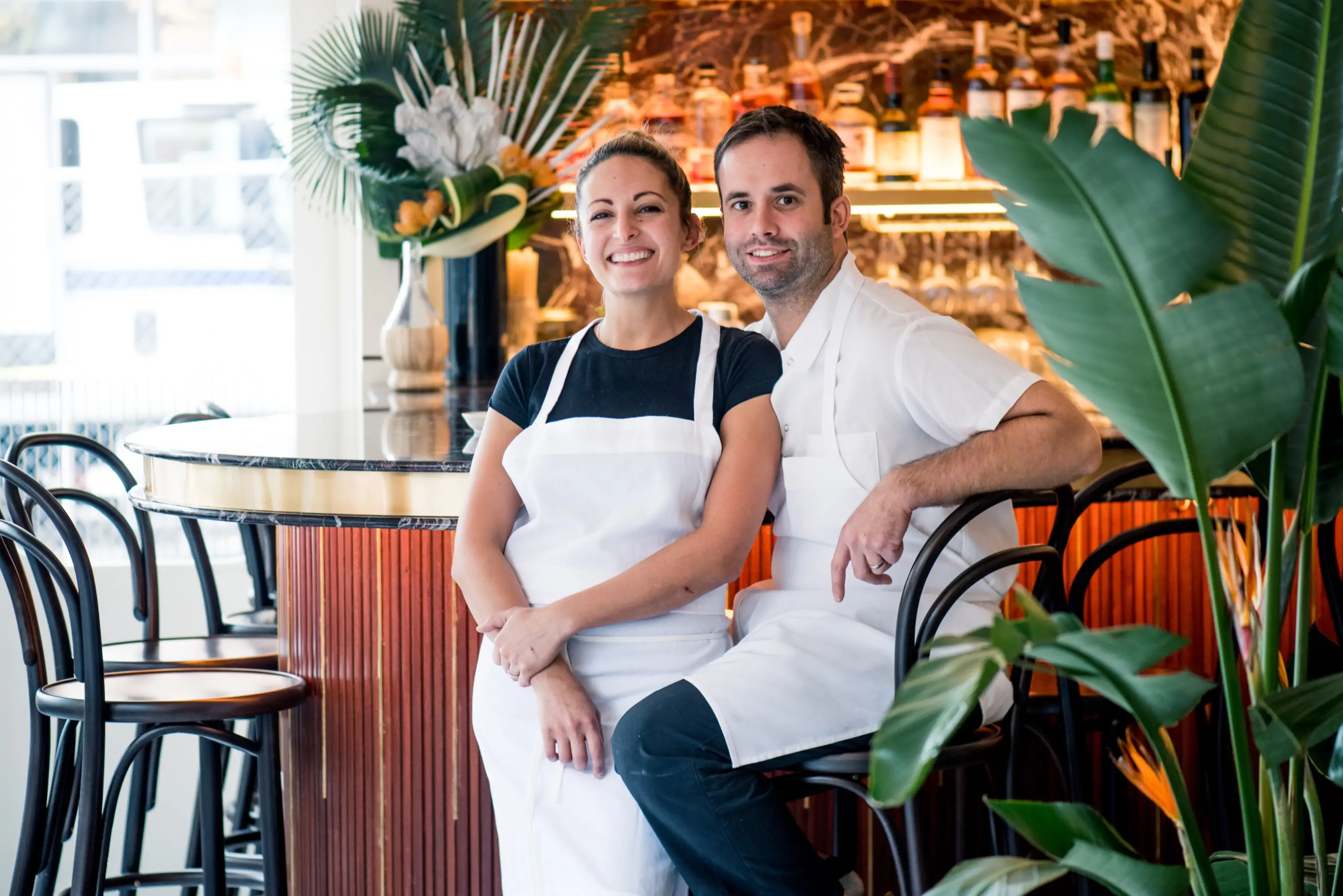 The chefs Angie Rito and Scott Tacinelli sitting at the bar of their NYC restaurant Don Angie