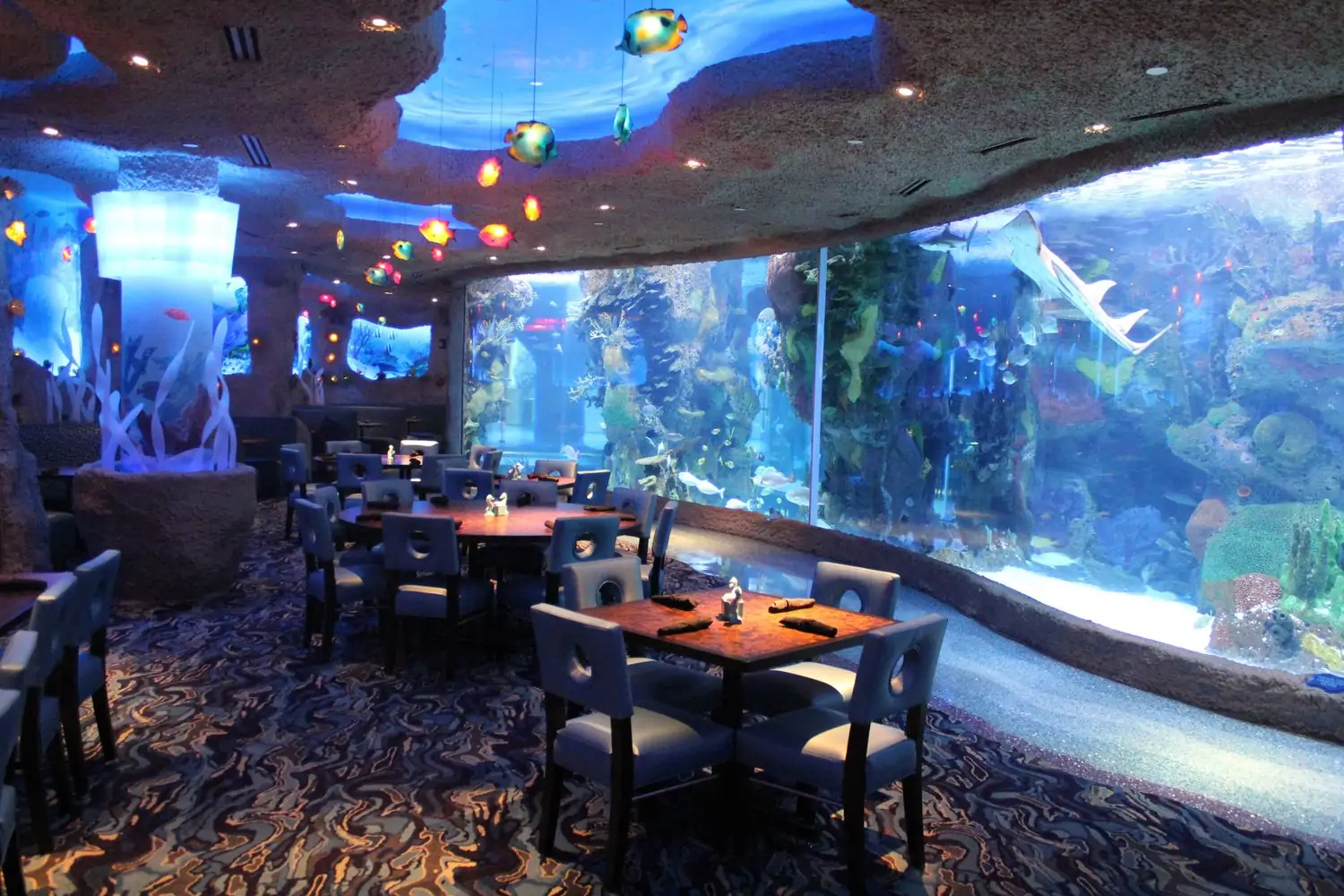 Wooden tables, comfortable settings, and a massive aquarium inside compose the Aquarium Restaurant, an OpenTable good family restaurant in Nashville.