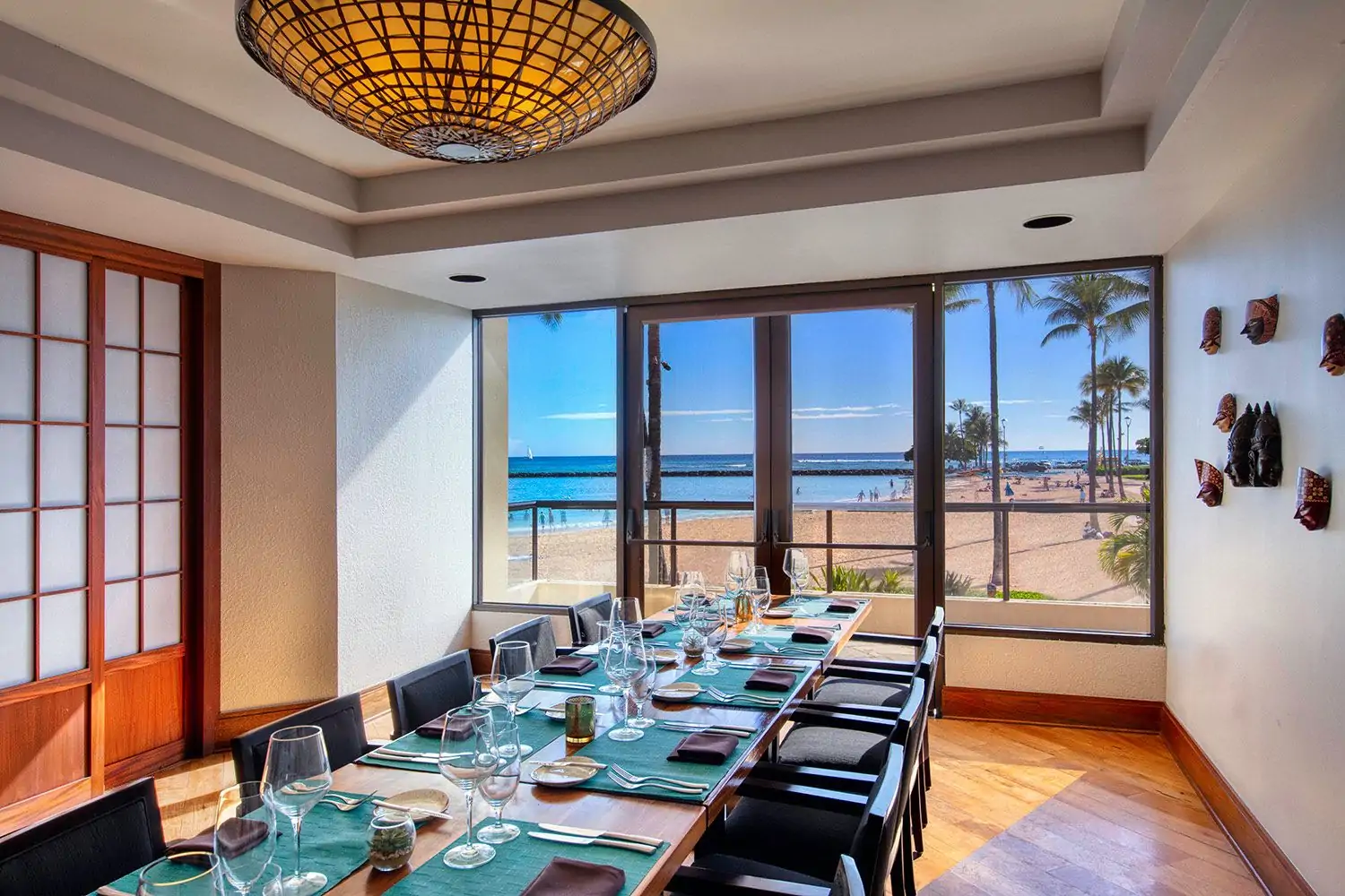 A private dining room with a beach view through the window at Bali Oceanfront, one of the best family restaurants in Honolulu. Book on OpenTable.