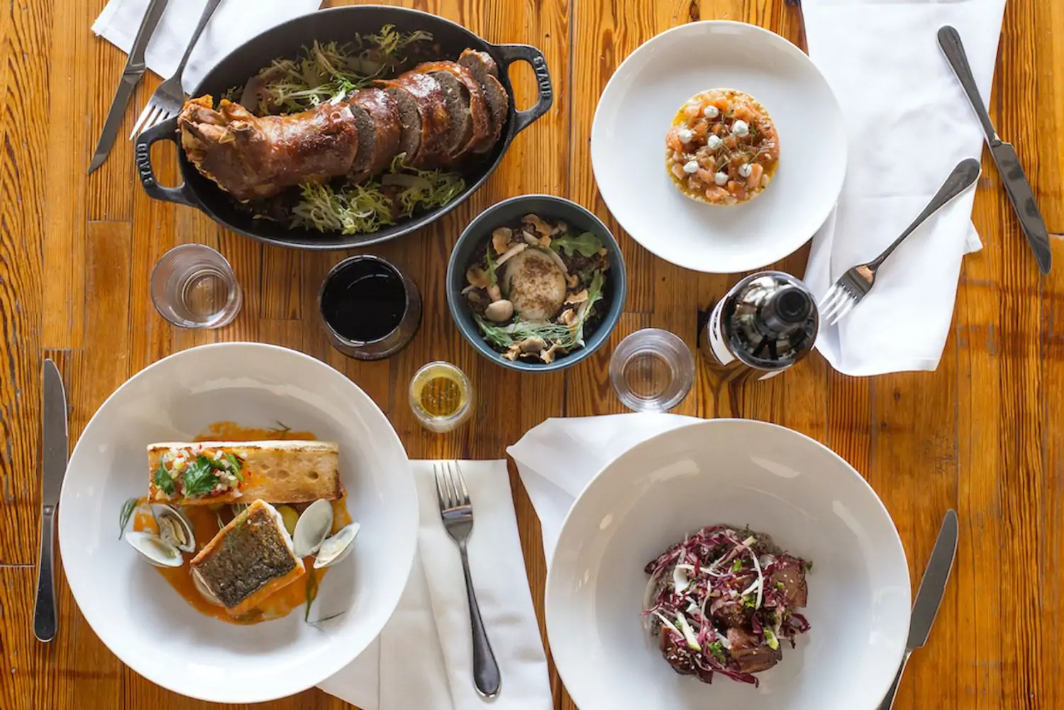 An aerial view of four contemporary American dishes at Foreign & Domestic, one of the best family restaurants in Austin. Book on OpenTable.