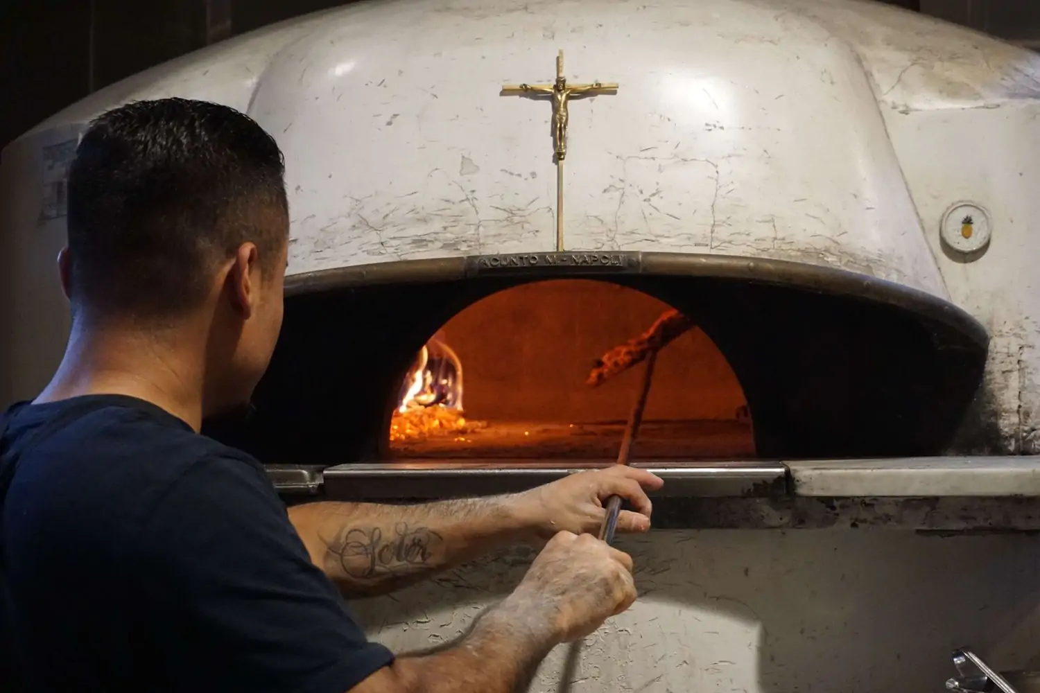 A pizza being placed in a pizza oven at Los Angeles restaurant Ronan