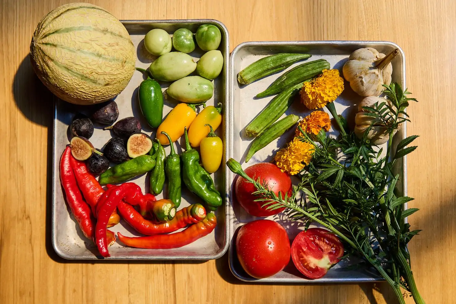 Several fruits and vegetables placed on steel trays at Nashville restaurant Rolf and Daughters