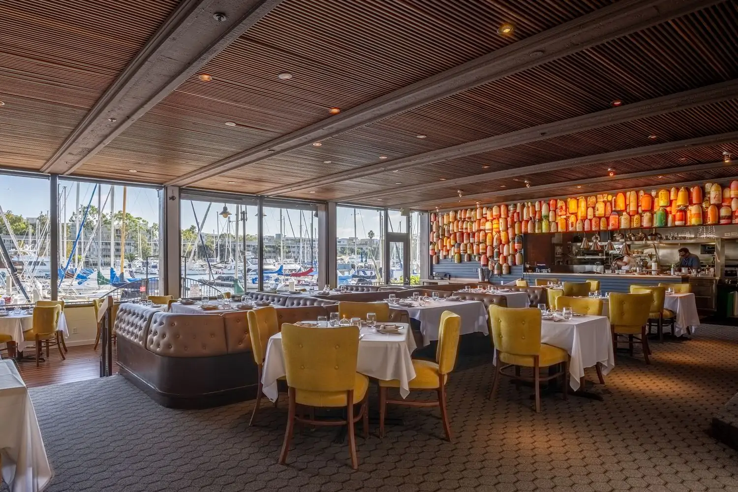 The interior of Los Angeles restaurant Dear Jane’s with windows looking out on the marina