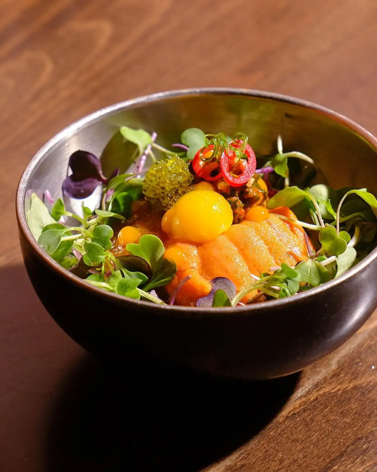 A bowl of sea urchin topped with caviar and egg yolk at Kochi, one of the best Hell's Kitchen restaurants in NYC, on OpenTable.