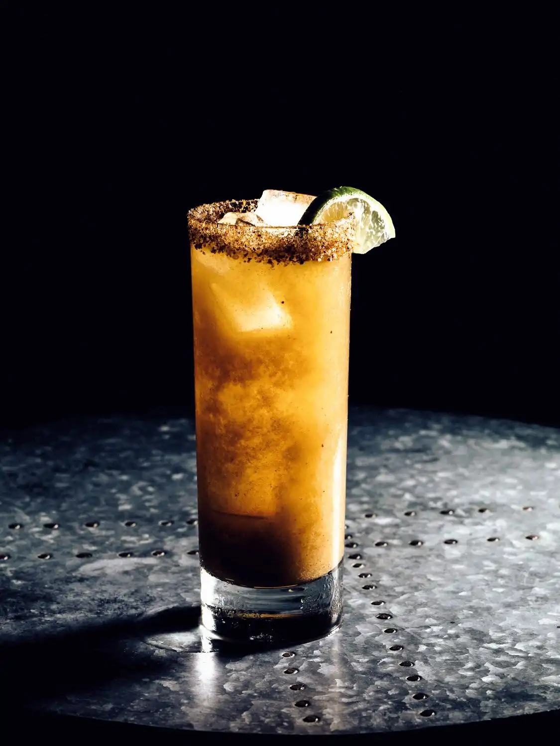 A tall cocktail with a lime wedge at Connie and Ted’s, one of the best casual restaurants in West Hollywood, available on OpenTable.