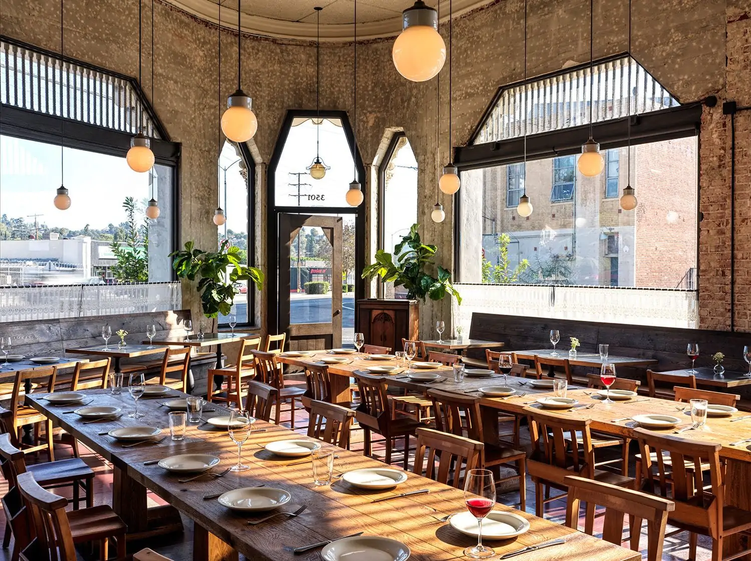The brick-lined interior of Dunsmoor which features wooden tables and orb lights above