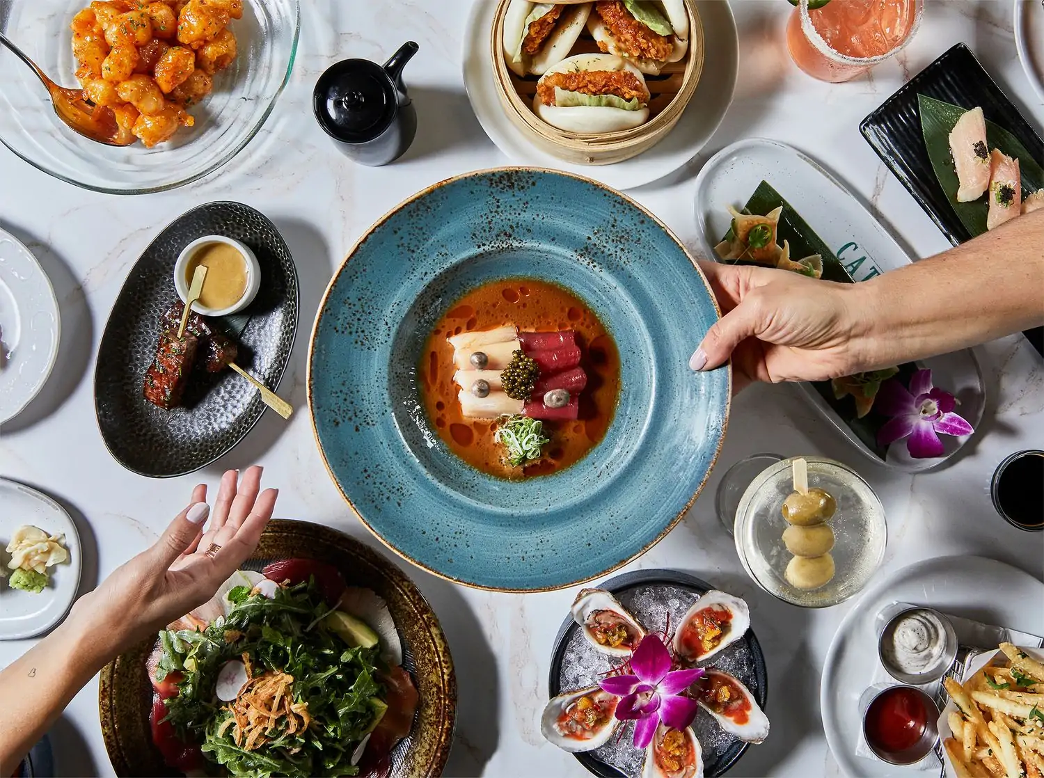 People passing appetizers and elegant seafood dishes at Catch LA in Los Angeles. Book on OpenTable.