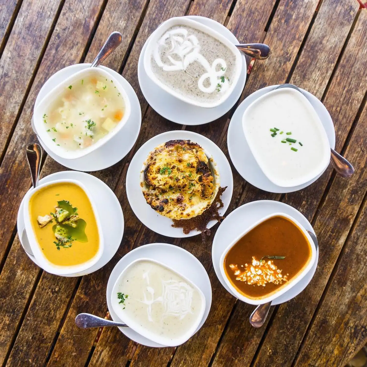 An aerial view of various French American soups at WeHo Bistro in West Hollywood, available on OpenTable.
