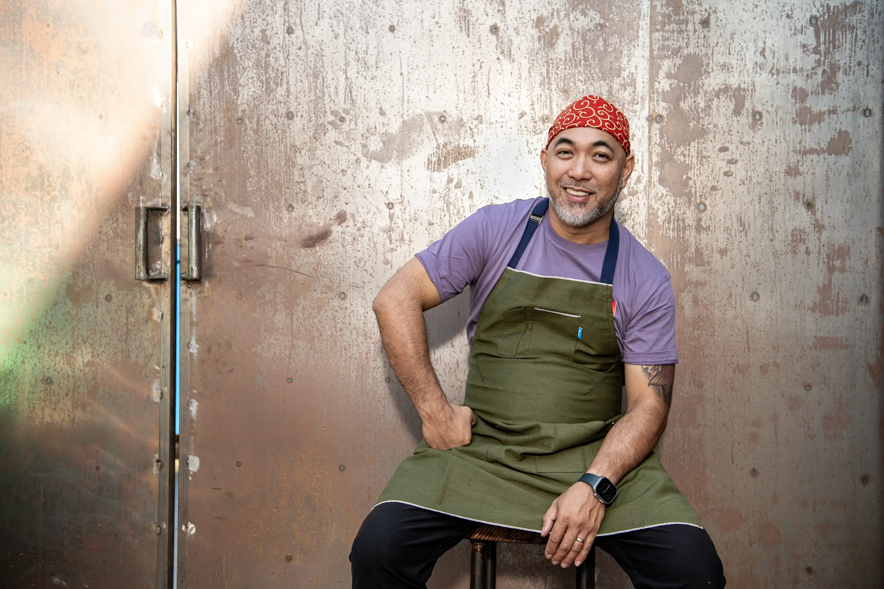 The Los Angeles chef Lord Maynard Llera sitting at his restaurant Kuya Lord