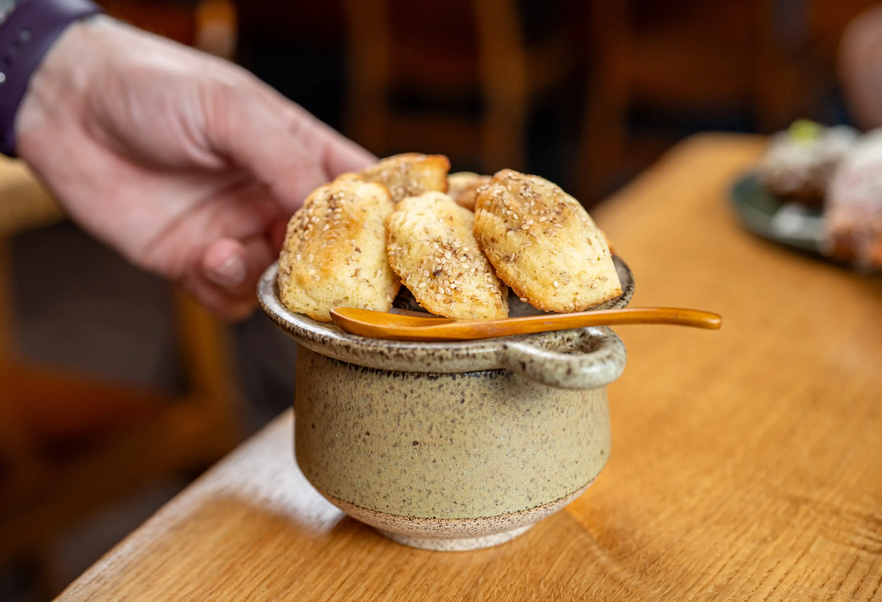 A handful of savory madeleine cookies on a pot at Philadelphia restaurant Emmett