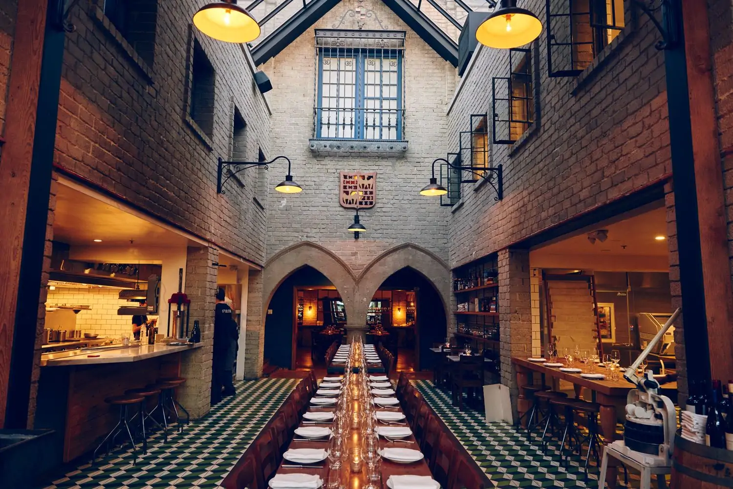 The interior of Los Angeles restaurant République with arched doors and red brick all around