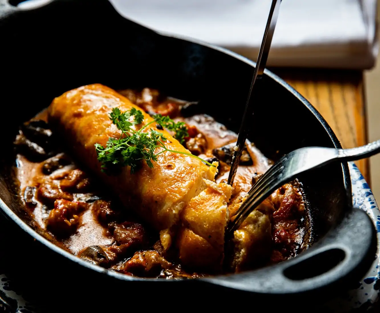 A French dish called quenelle in a black cast-iron pan at Charles restaurant NICO Seafood + Oyster