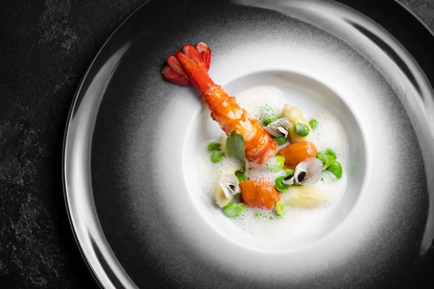 A lobster dish in a black and white bowl at Los Angeles restaurant Providence