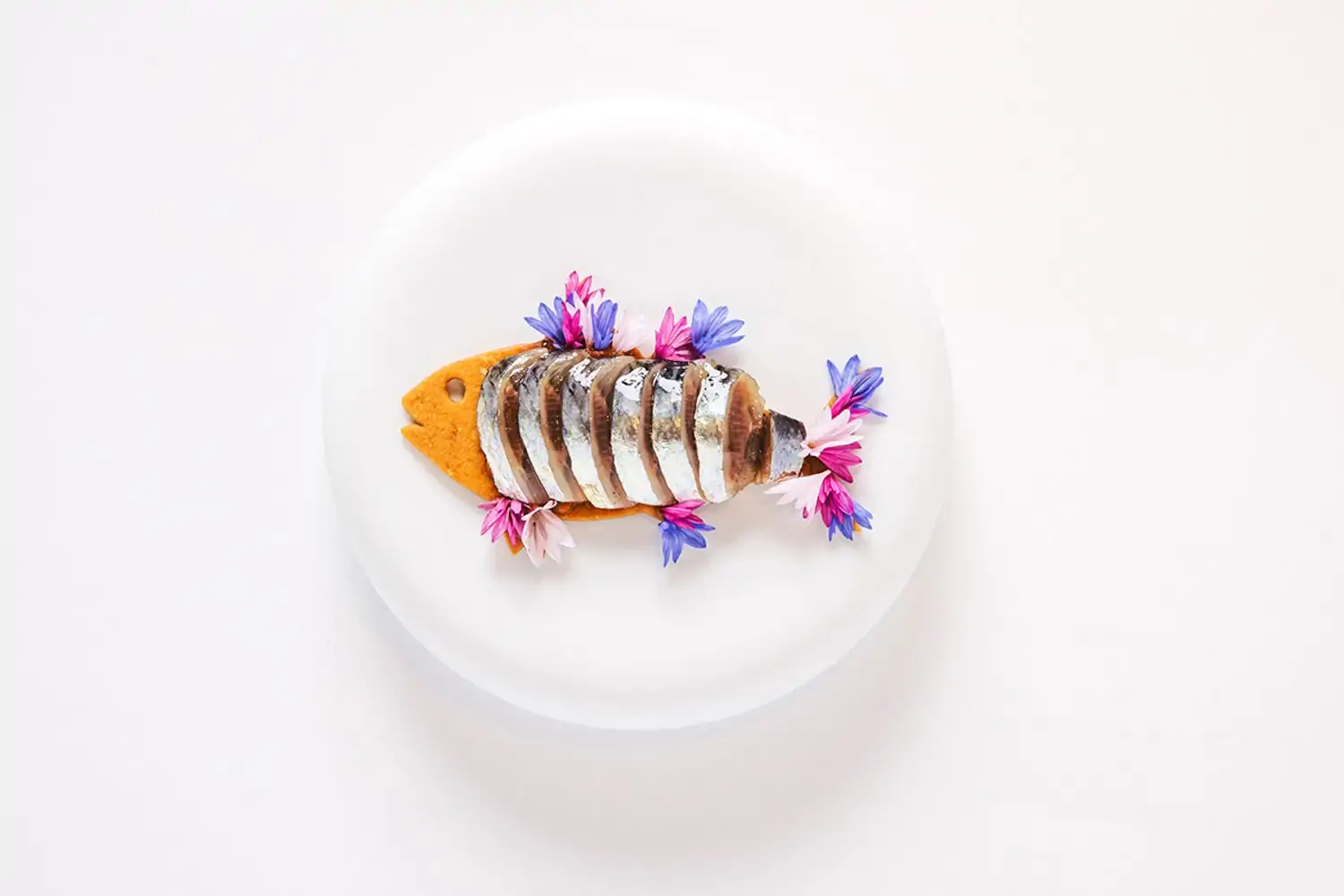 A fish dish in a white plate at Los Angeles restaurant Somni