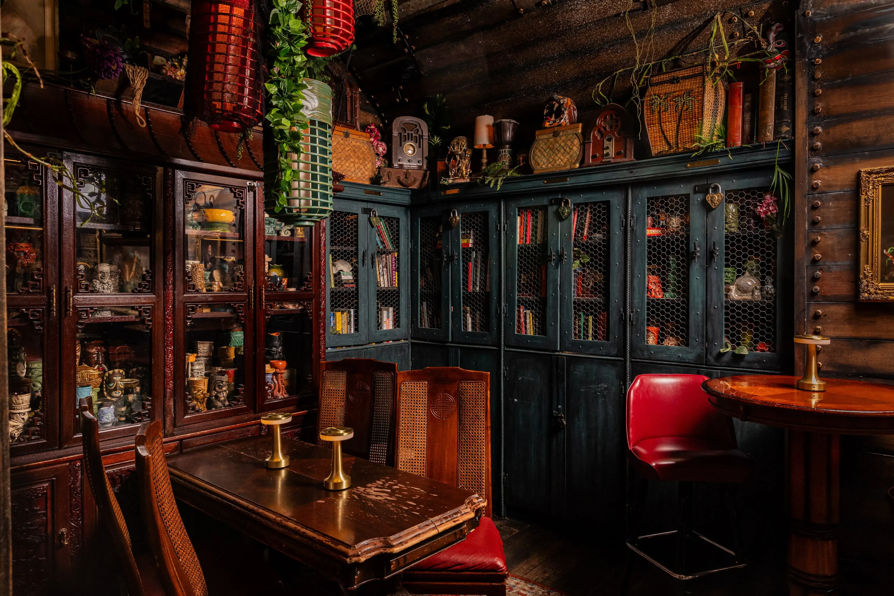 The interior of Anaheim tiki bar Strong Water featuring cabinets with tiki curious and a few seats in the front