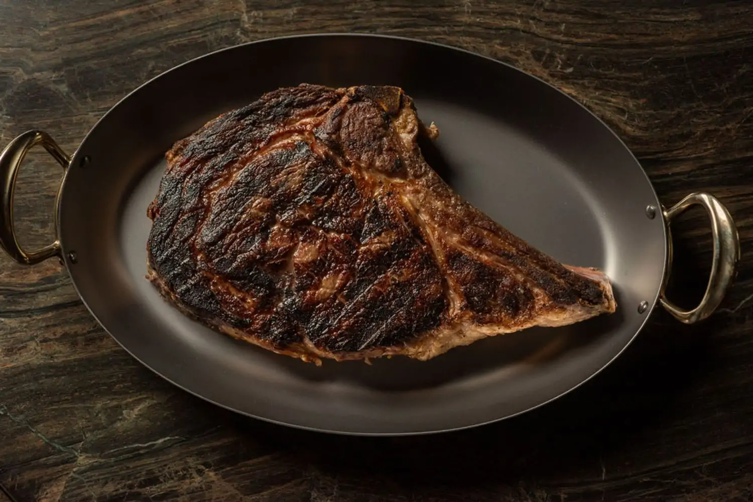 A steak in a tray at Chicago restaurant The Alston