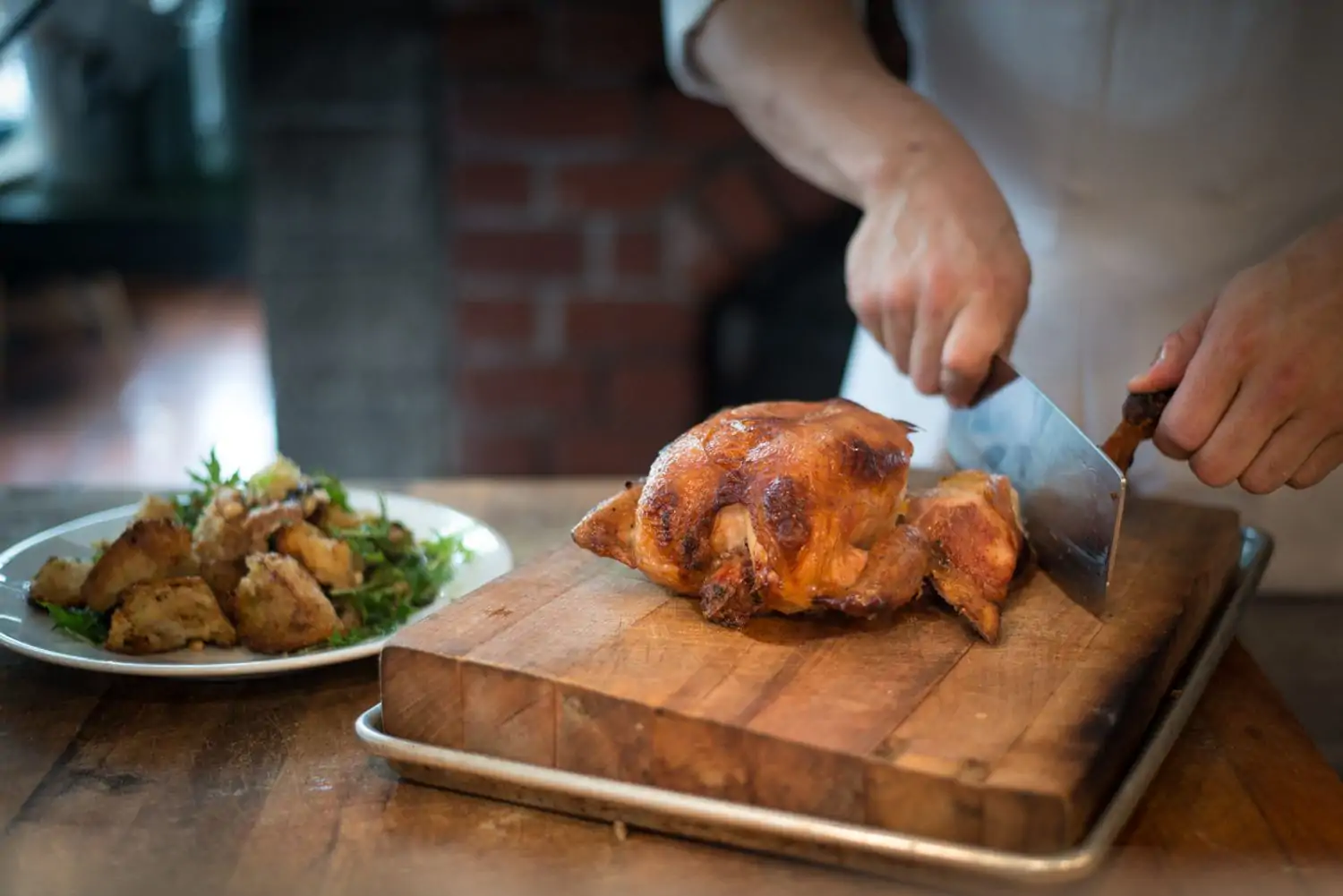The roast chicken and bread salad dish at San Francisco restaurant Zuni Cafe