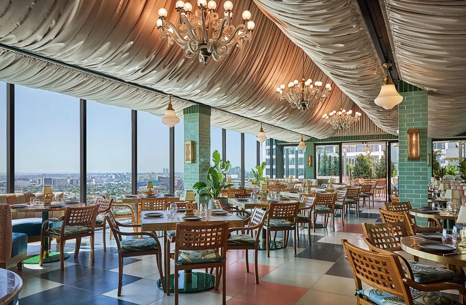 The dining room with floor-to-ceiling windows and wooden furniture, at Merois, one of the best restaurants in Los Angeles, on OpenTable.