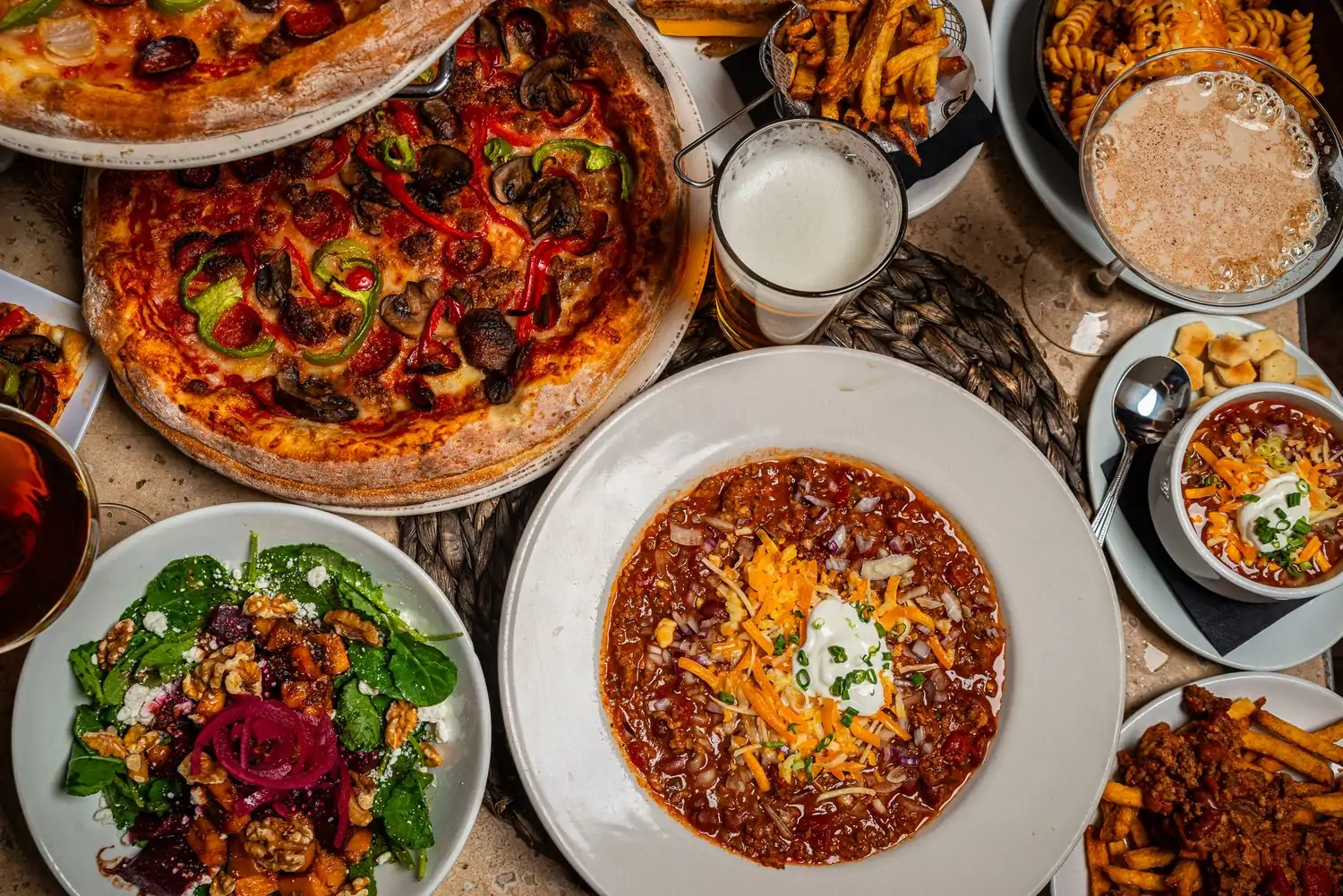 An overhead view of pizza and comfort food from Lark, one of the best restaurants in Lakeview, Chicago, available on OpenTable.